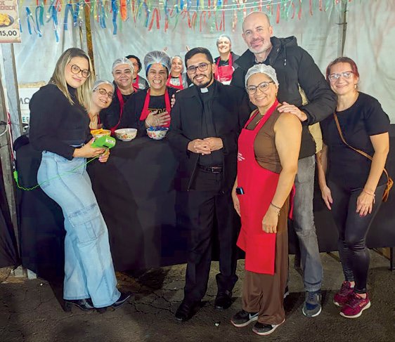 Padre Luís ao lado de voluntários da comunidade Santa Rita